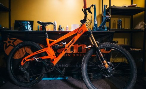 Orange Alpine 6 displayed in mechanics area in Morzine